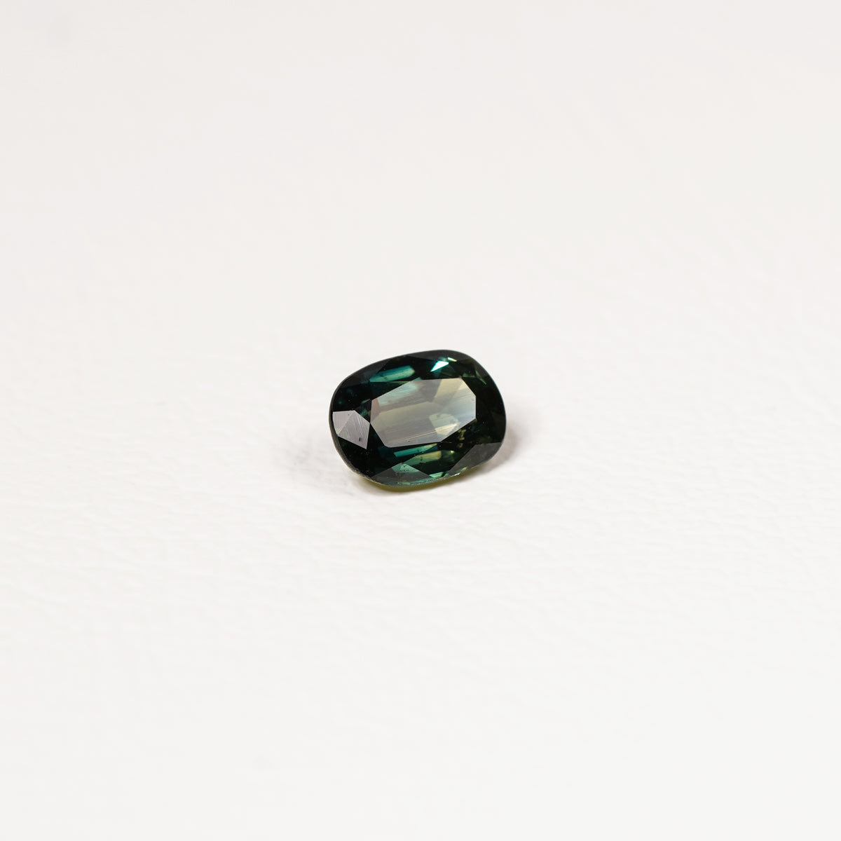 Australian Teal 1.15CT Oval cut sapphire hand view — Ruhuna Gemstones