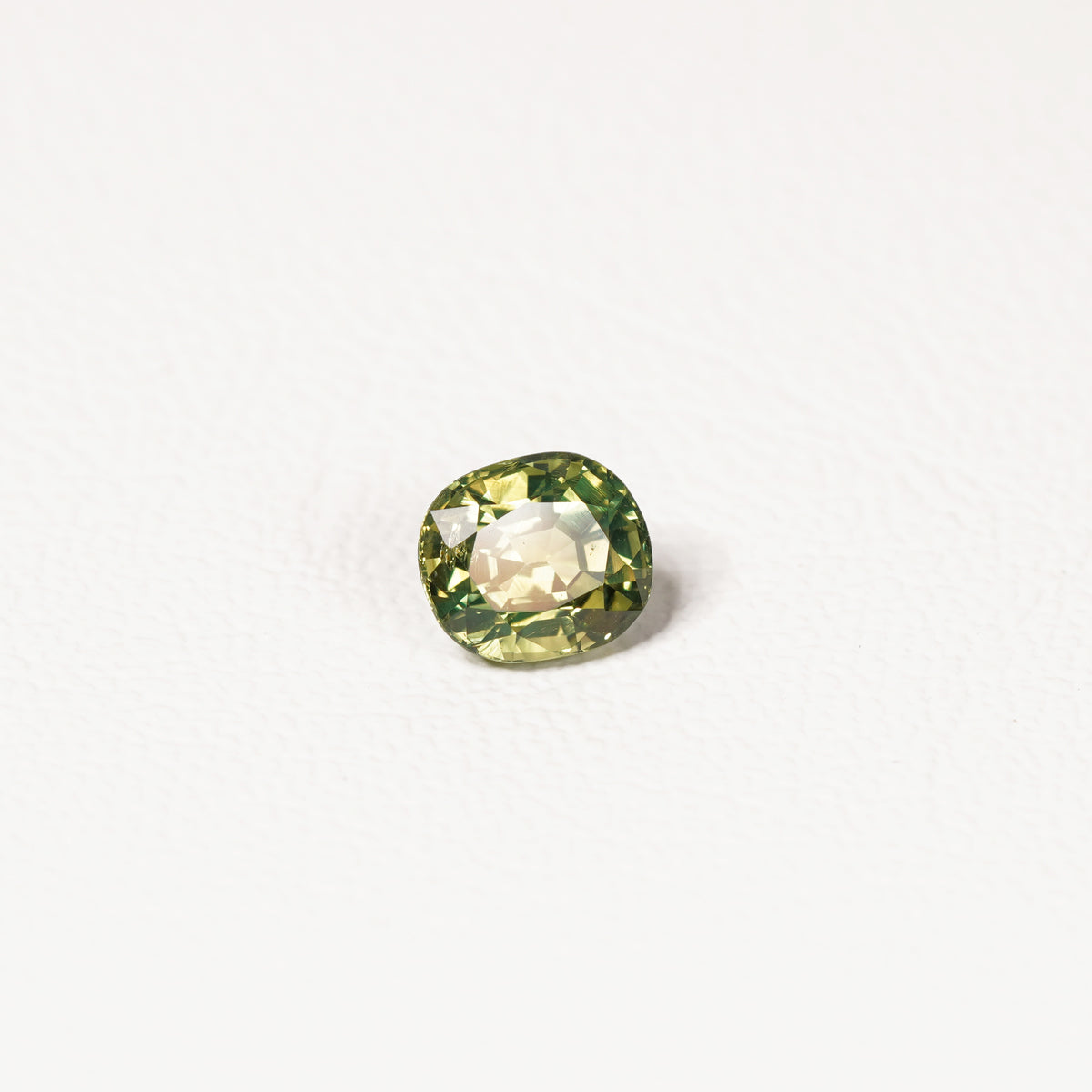 1.70ct Australian parti sapphire cushion — yellow-green centre with forest green crown, face-up — Ruhuna Gemstones