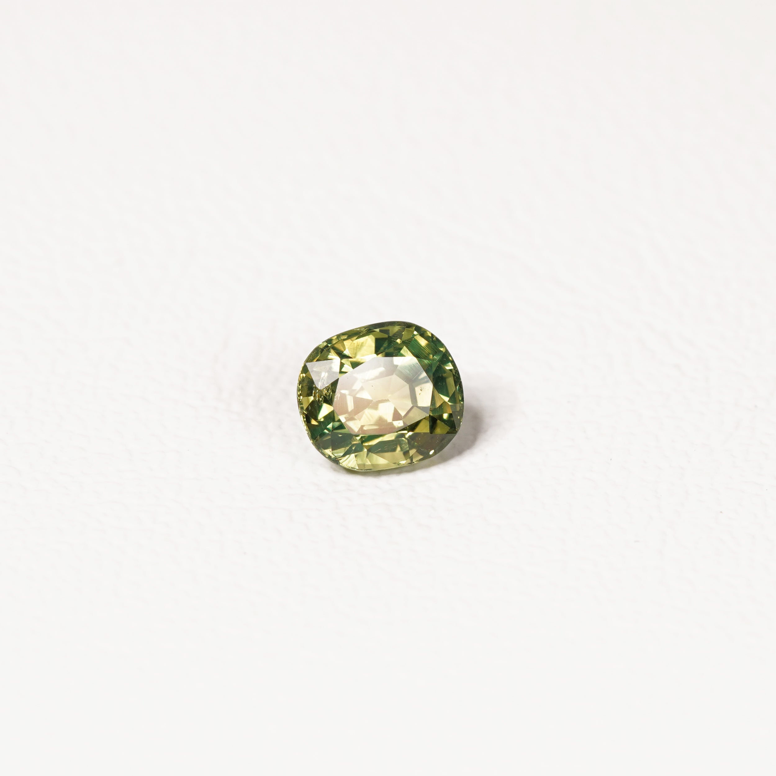 1.70ct Australian parti sapphire cushion — yellow-green centre with forest green crown, face-up — Ruhuna Gemstones
