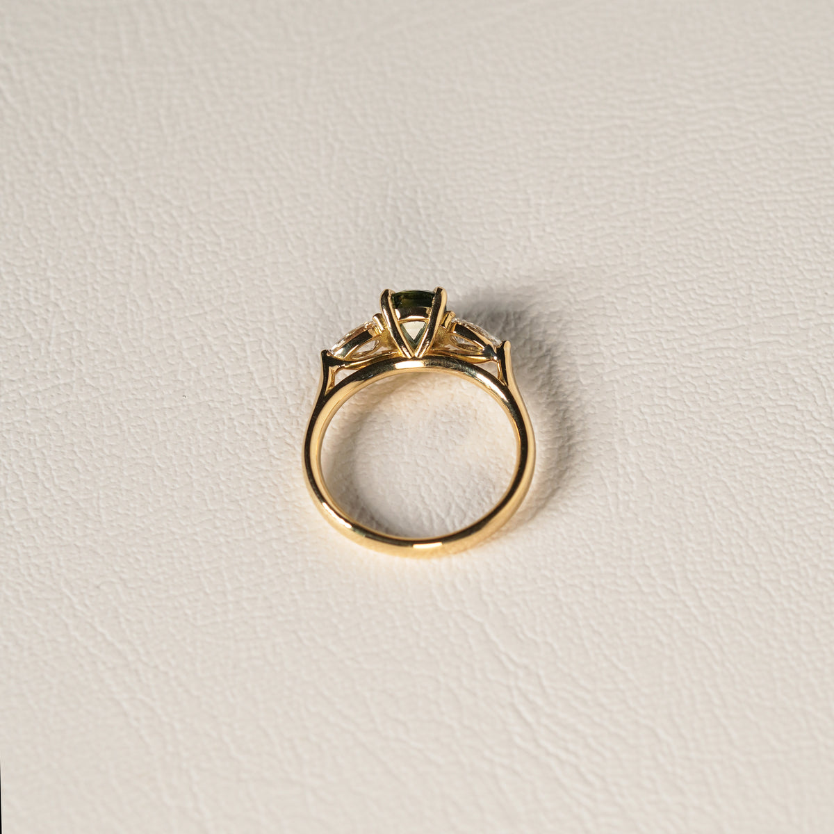 1.55 carat teal parti sapphire engagement ring with pair cut diamonds in 18ct yellow gold