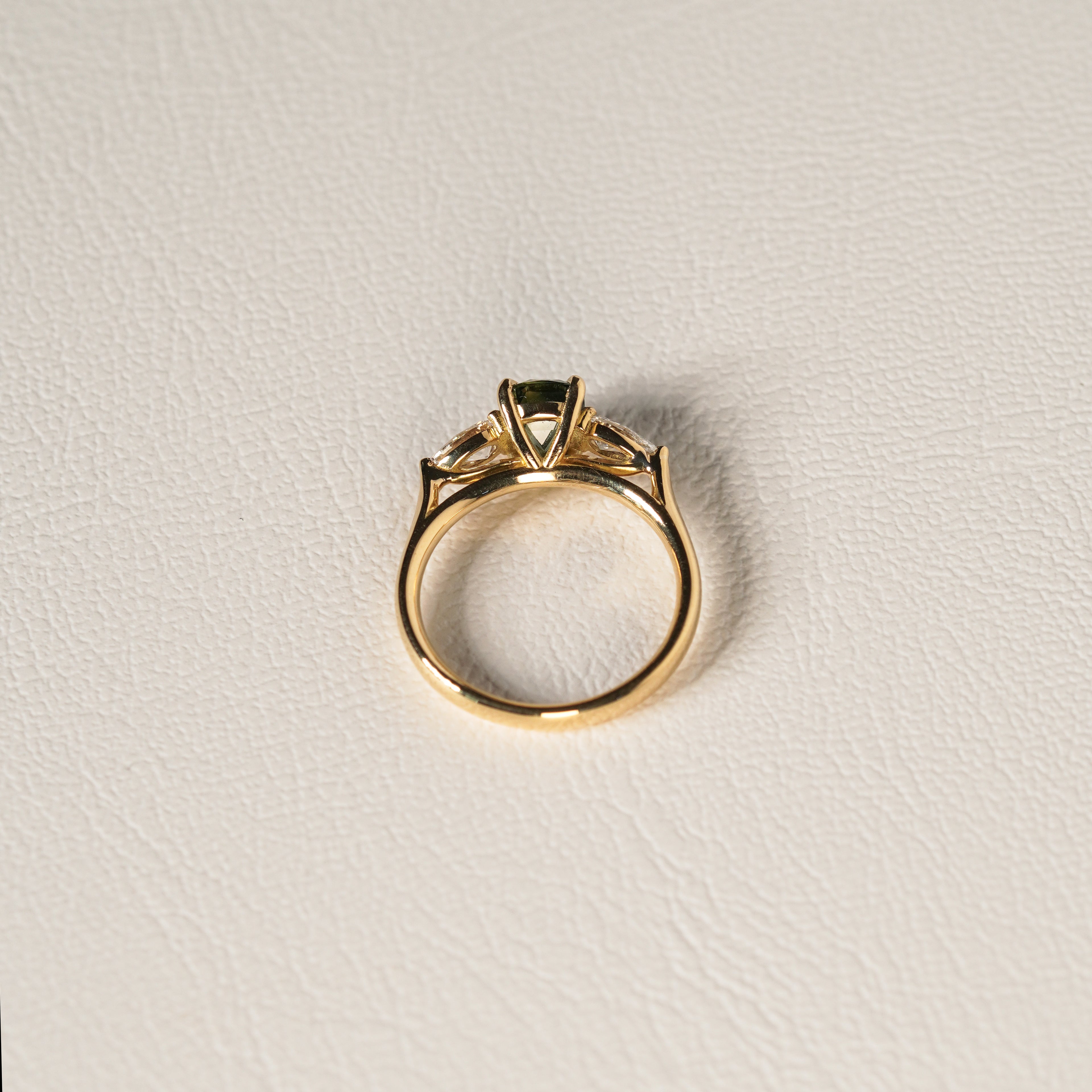 1.55 carat teal parti sapphire engagement ring with pair cut diamonds in 18ct yellow gold