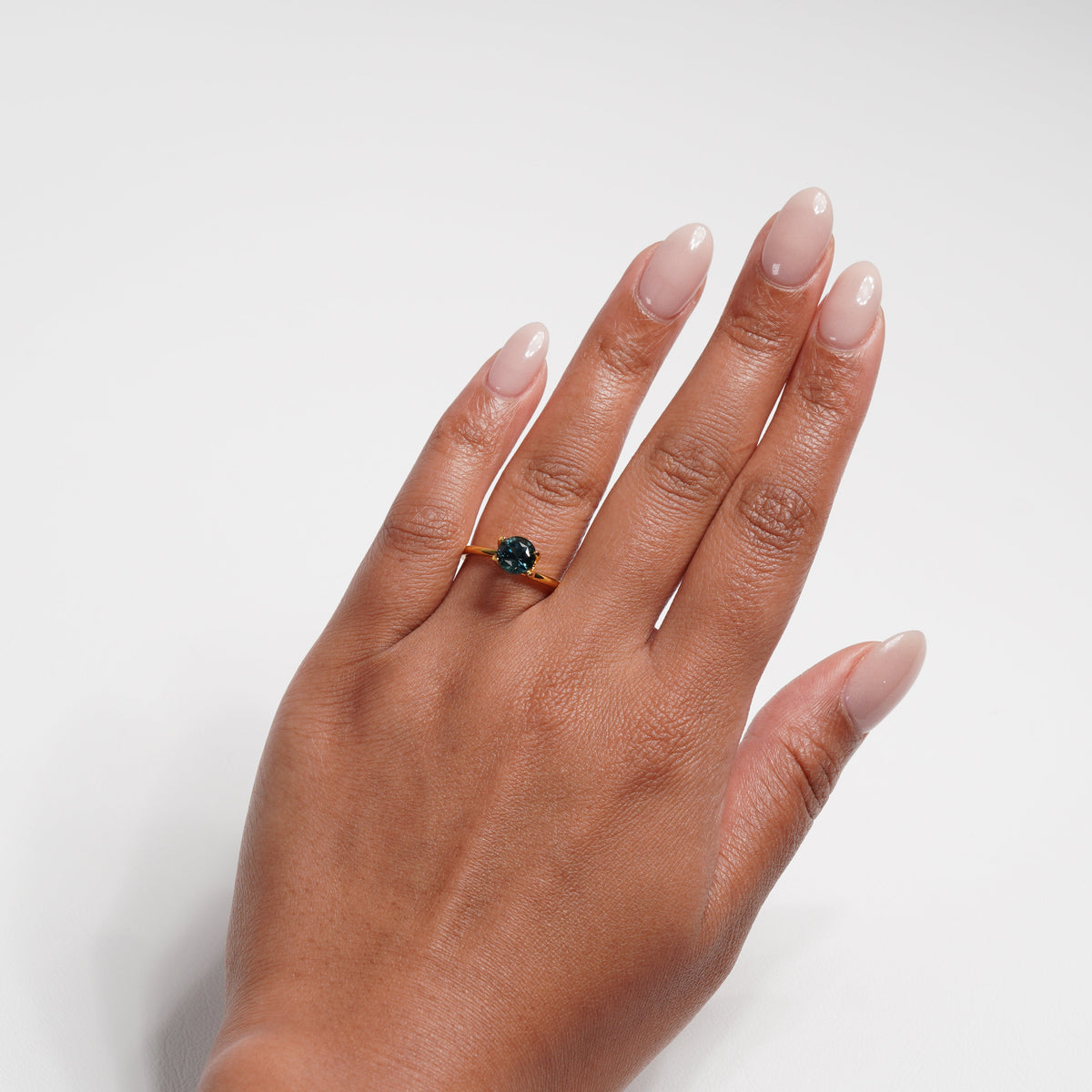 1.76 carat round parti teal sapphire ring with mixed green and blue color.