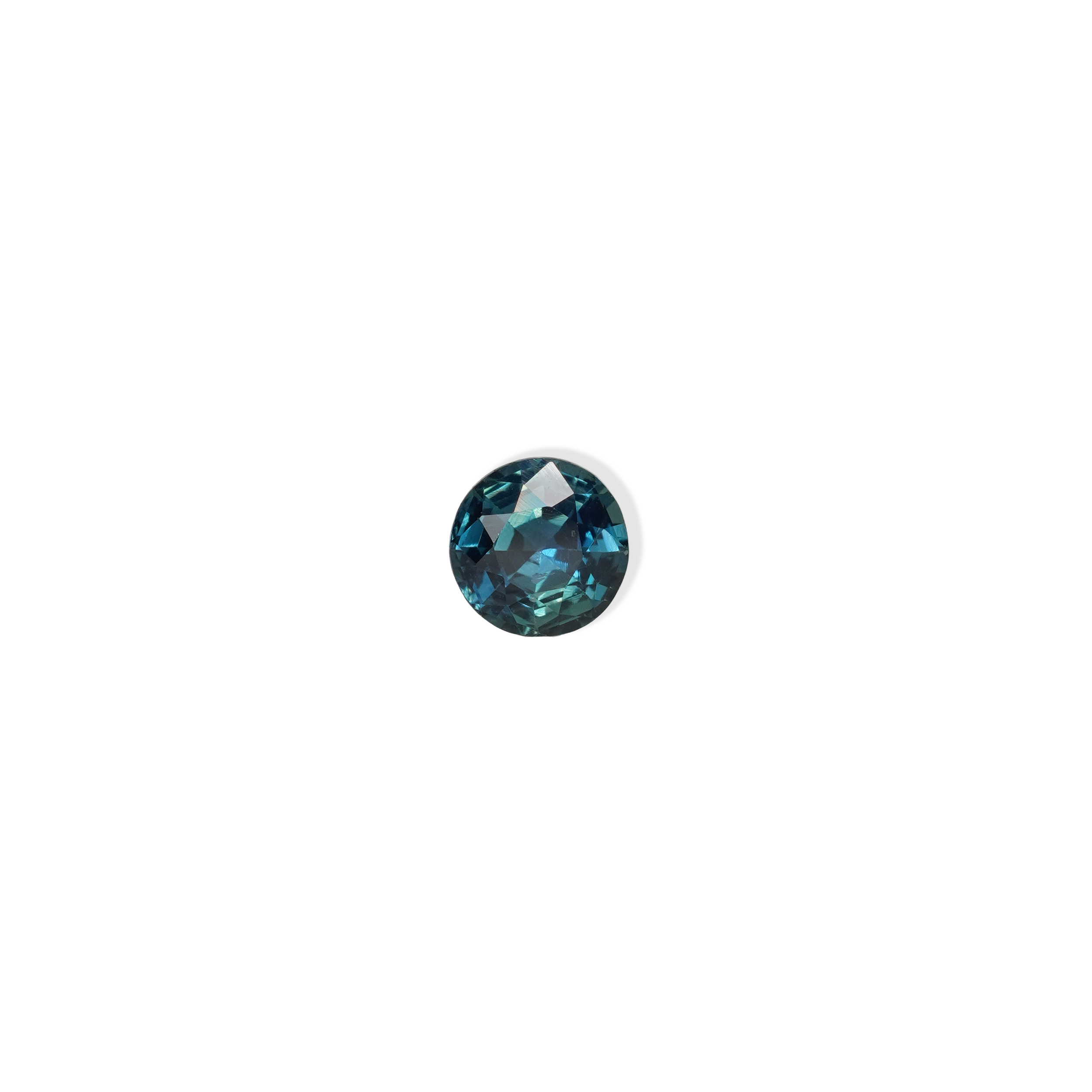 1.3 carat round parti teal sapphire with mixed green and blue color.