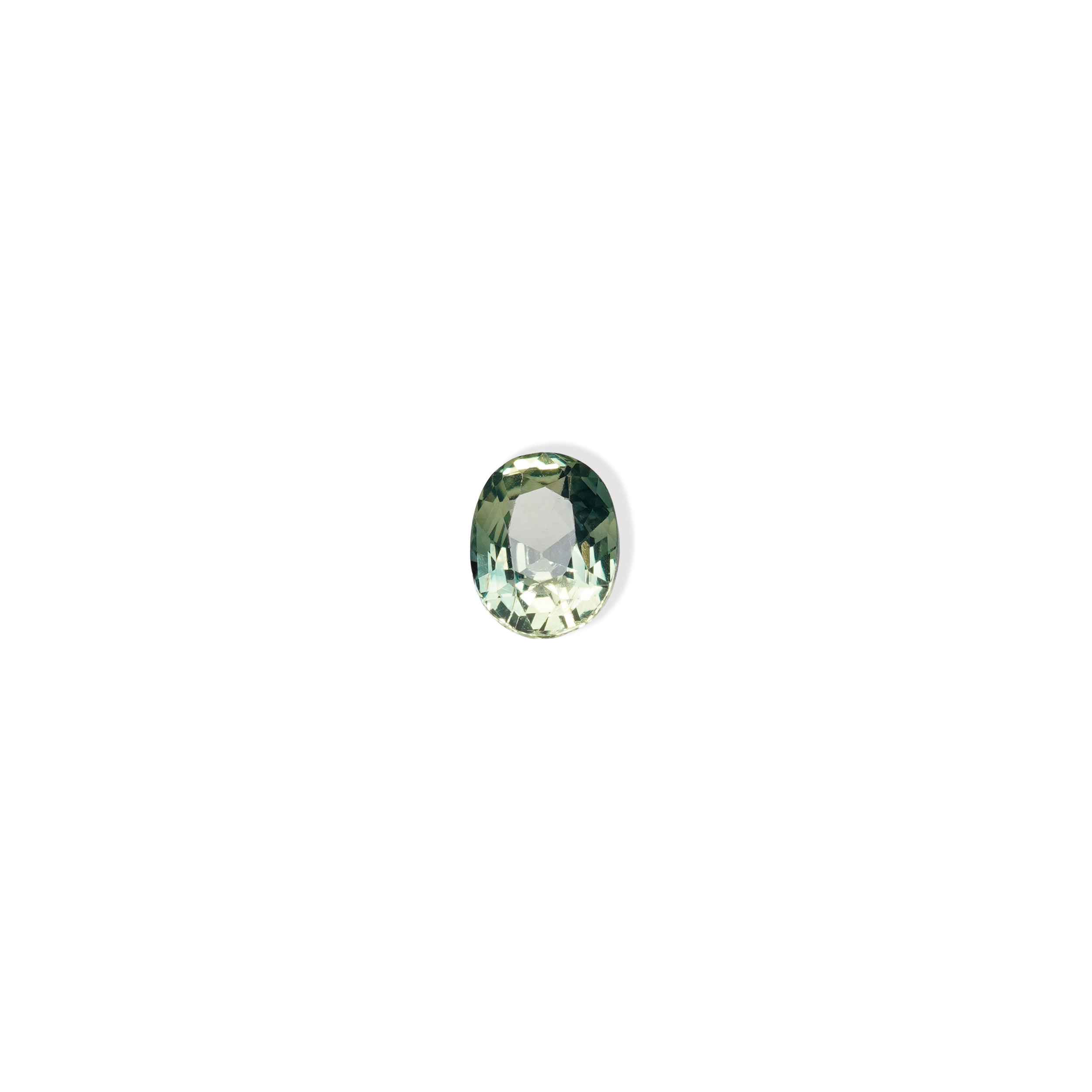 1.10 carat oval parti teal sapphire with mixed green and yellow color.