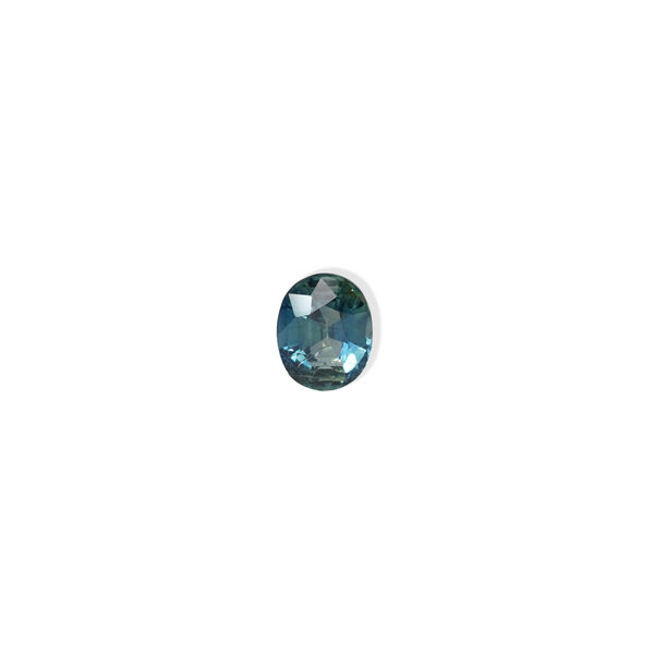 1.25 carat oval parti teal sapphire with mixed green and blue color.