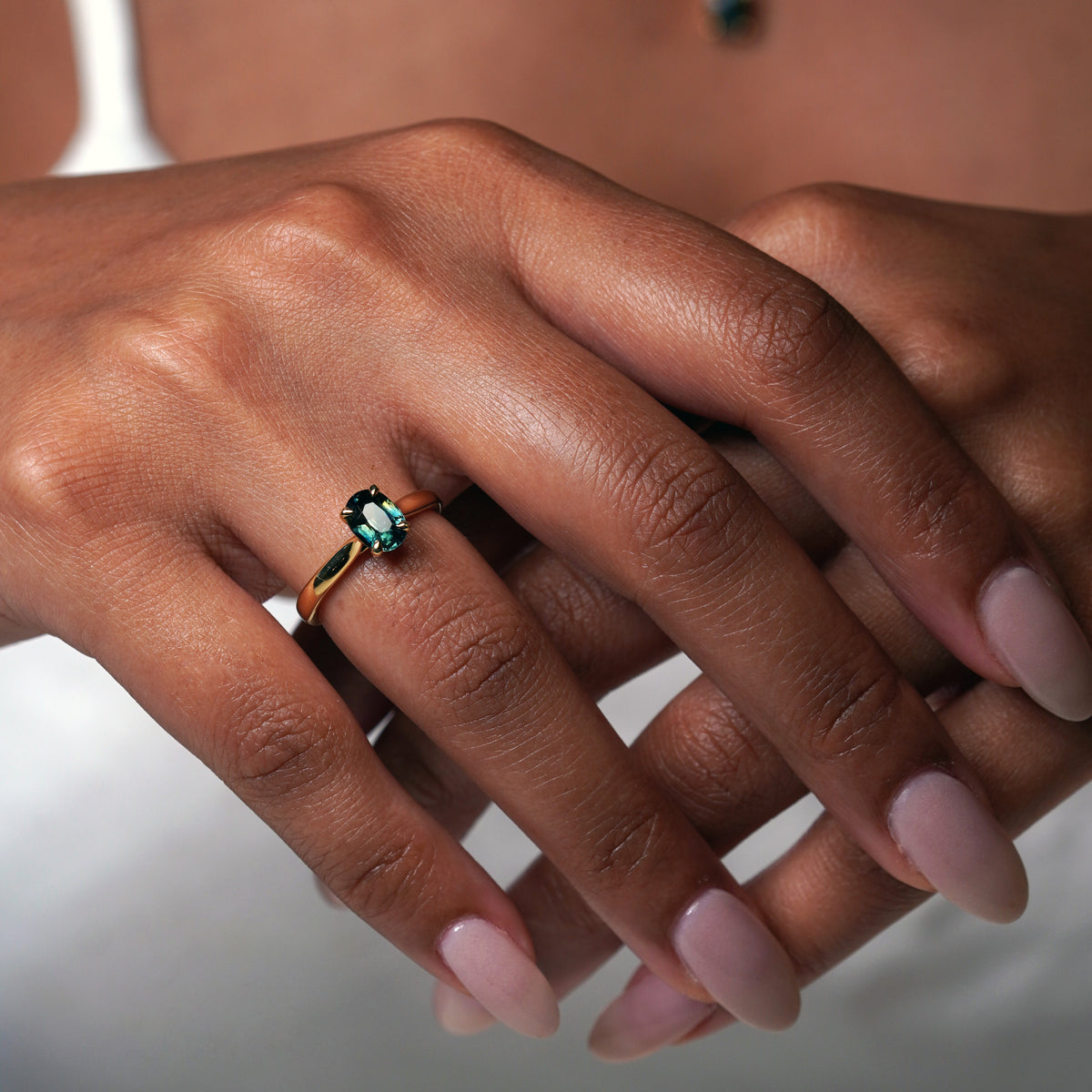 1.2 carat teal blue parti sapphire engagement ring with hidden halo in 18ct yellow gold. Cathedral settings 