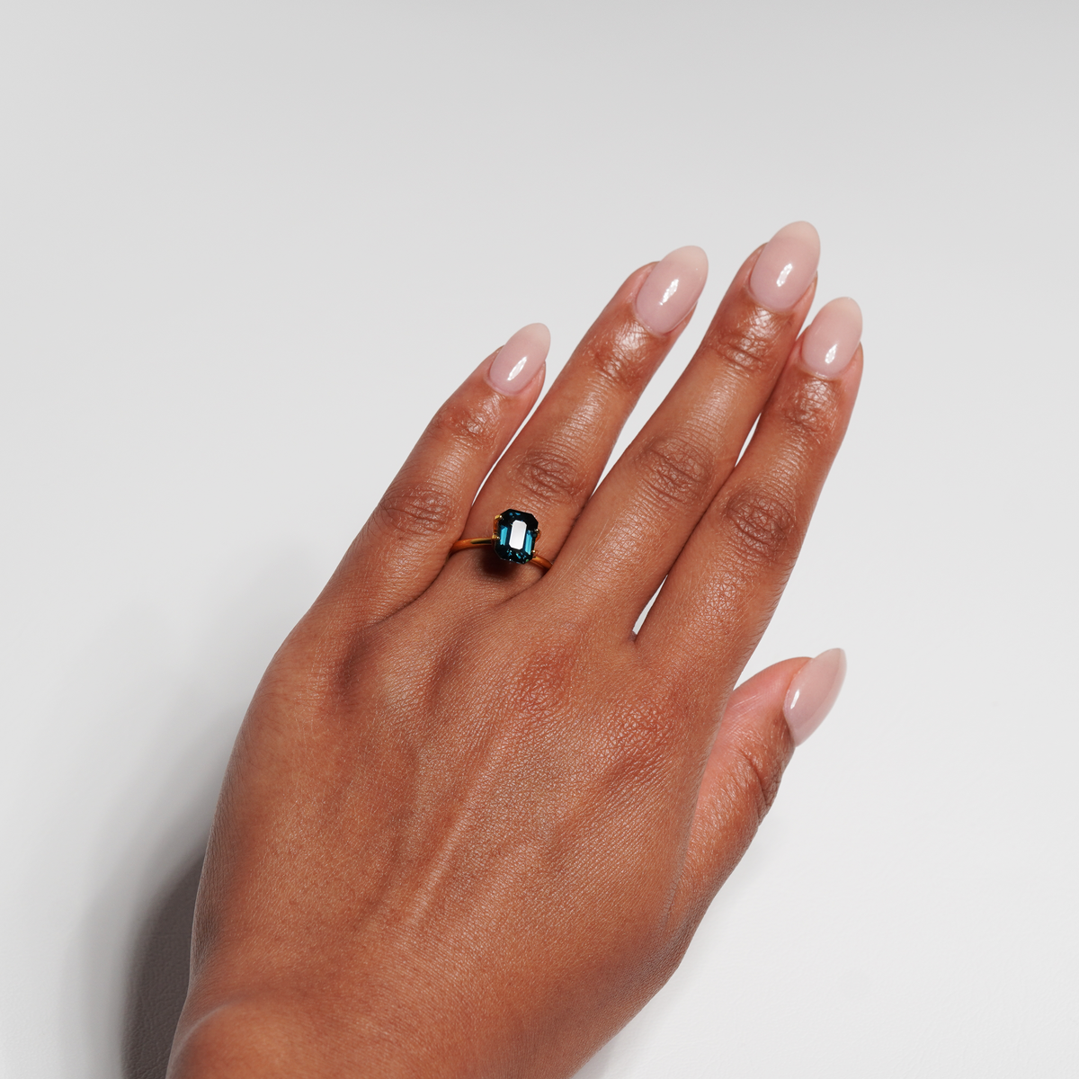 3.06 carat emerald cut teal parti sapphire ring with blue and green
