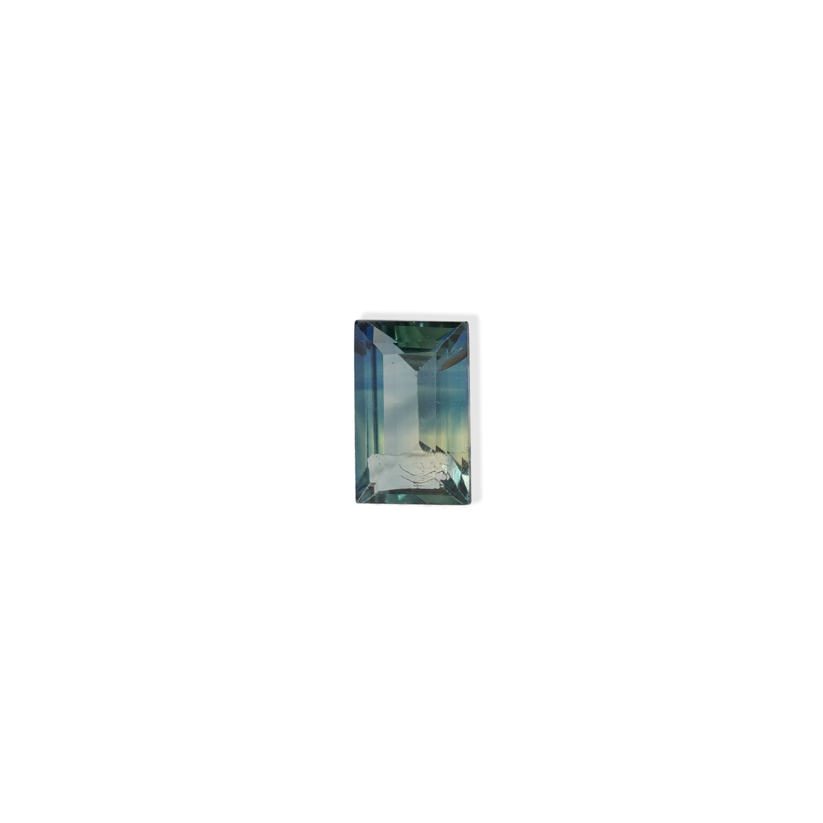 1.1 carat baguette parti teal sapphire with mixed green and blue color.