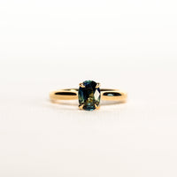 1.2 carat teal blue parti sapphire engagement ring with hidden halo in 18ct yellow gold. Cathedral settings 