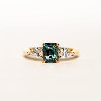 1.55 carat teal parti sapphire engagement ring with pair cut diamonds in 18ct yellow gold
