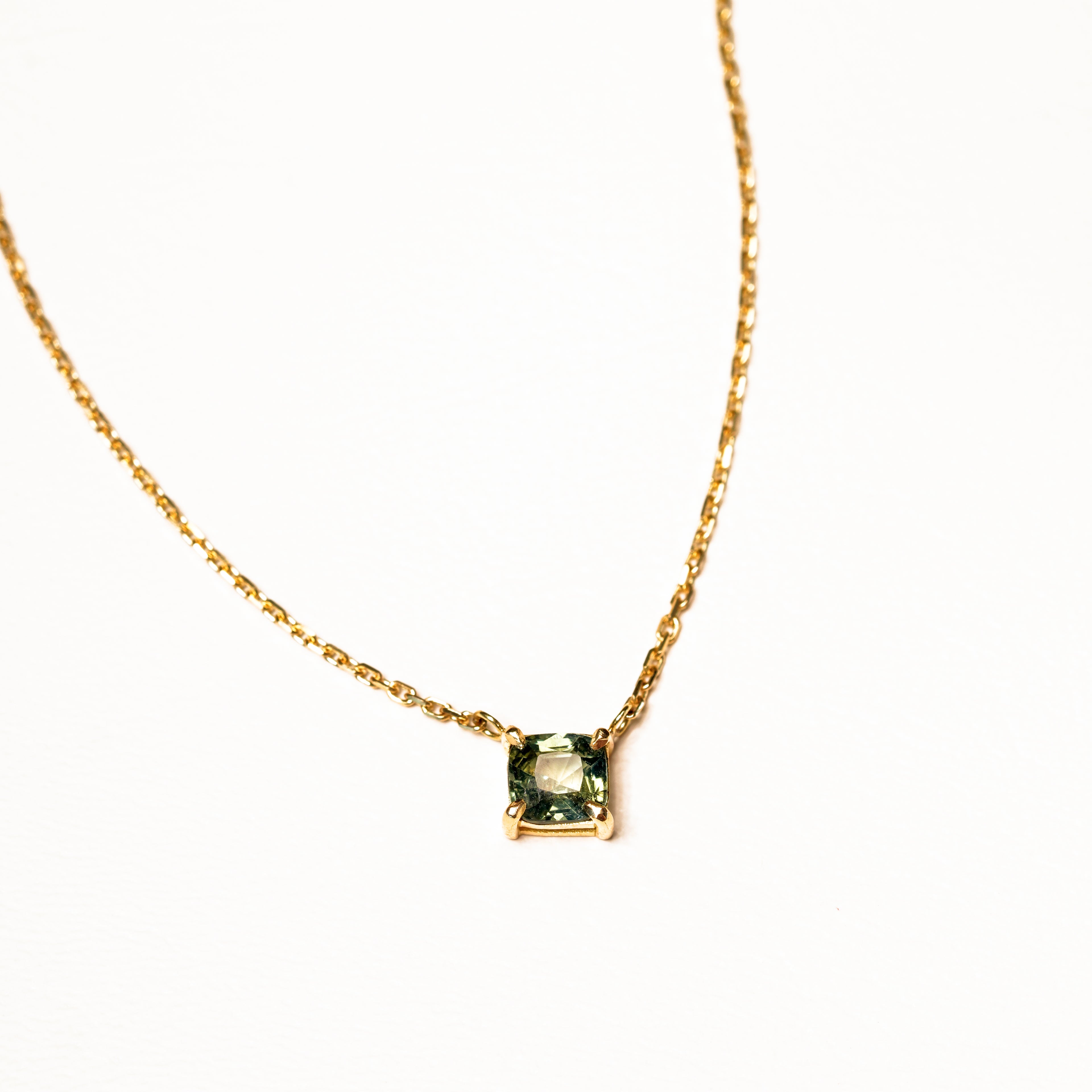 1 carat green teal parti sapphire integrated necklace with double gallery basket in 18ct yellow gold