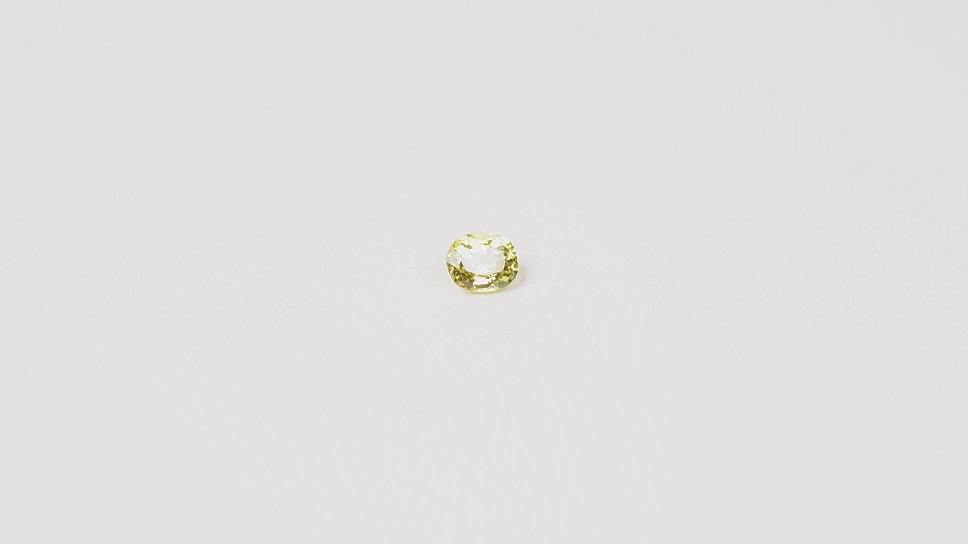 0.85ct Australian yellow-green sapphire cushion — soft pale chartreuse colour, face-up view — Ruhuna Gemstones