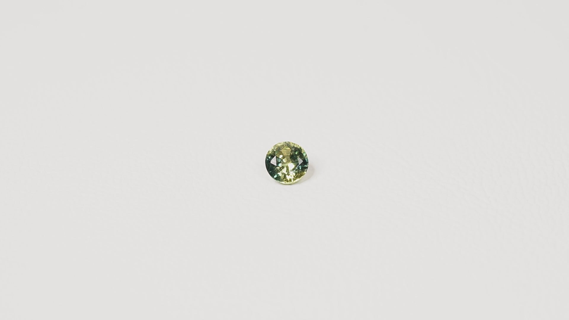 0.90ct Australian parti sapphire round — bright yellow-green body with teal crown accent, face-up — Ruhuna Gemstones