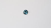 1 carat round parti teal sapphire with mixed green and blue color.