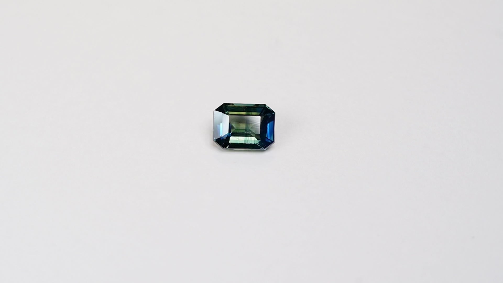 2.02 carat emerald cut teal parti sapphire with blue and green