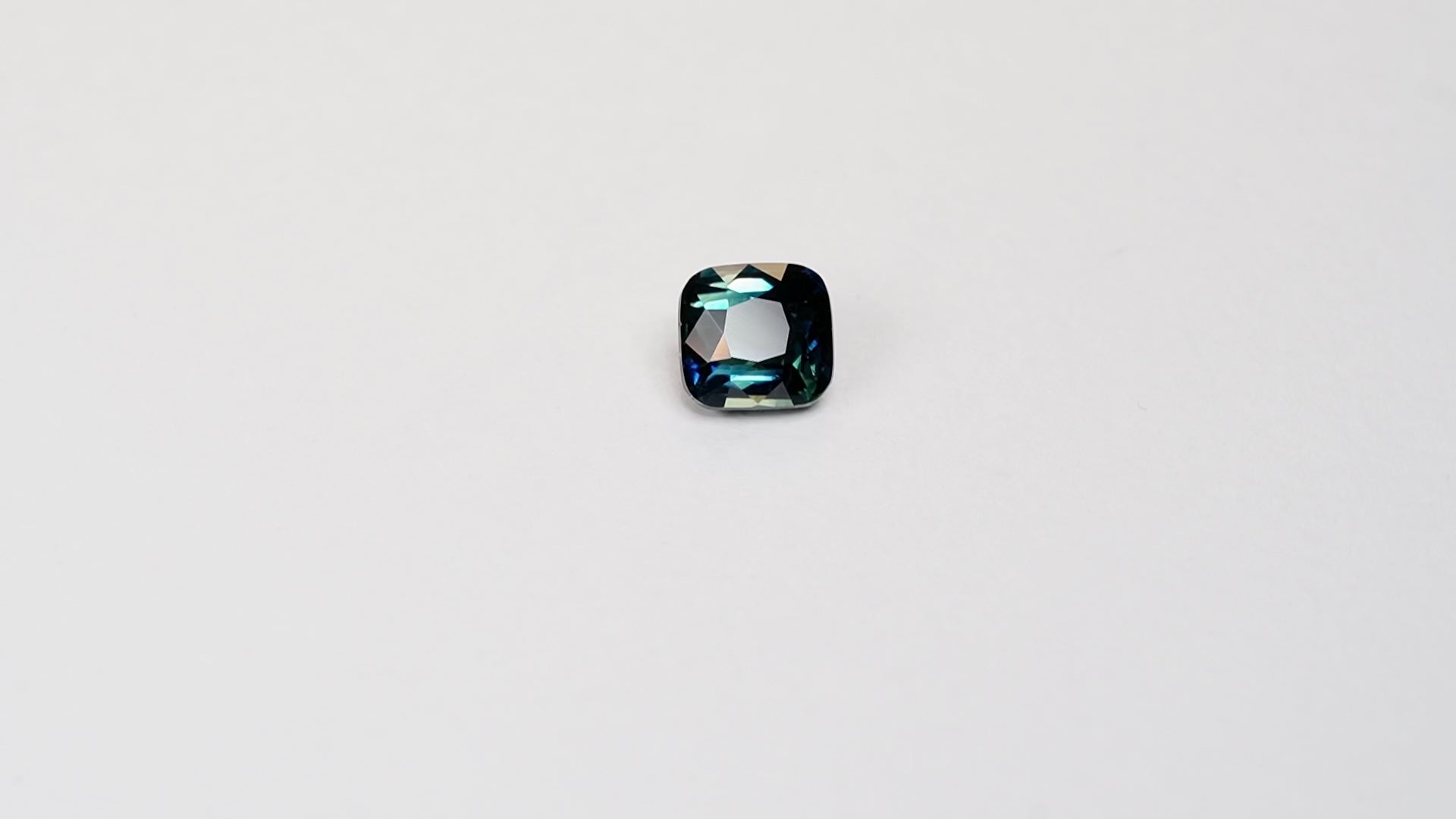 2.11 carat cushion cut teal parti sapphire with green and blue
