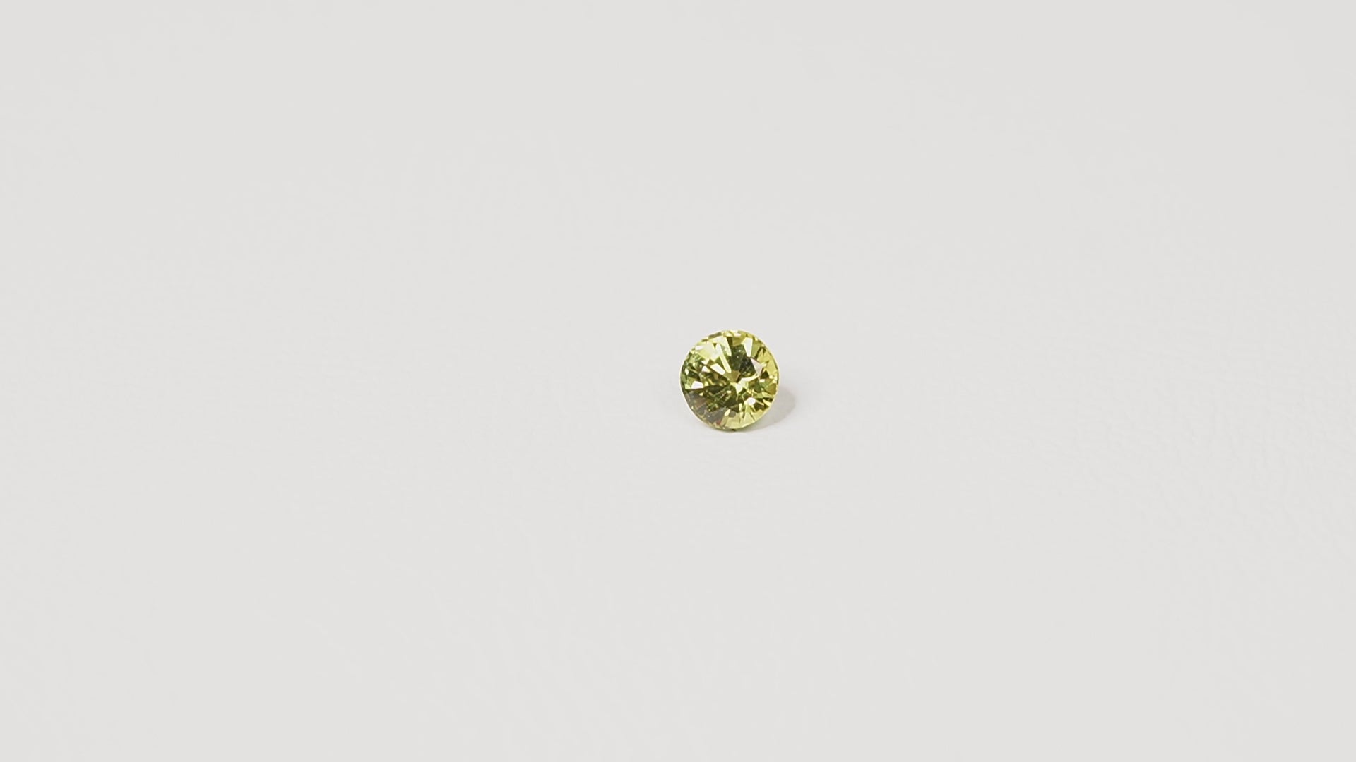0.95ct Australian yellow-green sapphire round brilliant — vivid lime yellow-green, face-up view — Ruhuna Gemstones