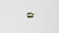 1.30 carat oval parti teal sapphire with mixed green and yellow color.
