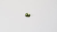 1 carat pear parti teal sapphire with mixed green and yellow color.