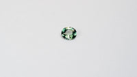 1.3 carat oval parti teal sapphire with mixed green and blue color.