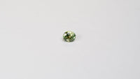 1 carat pear parti teal sapphire with mixed green and yellow color.