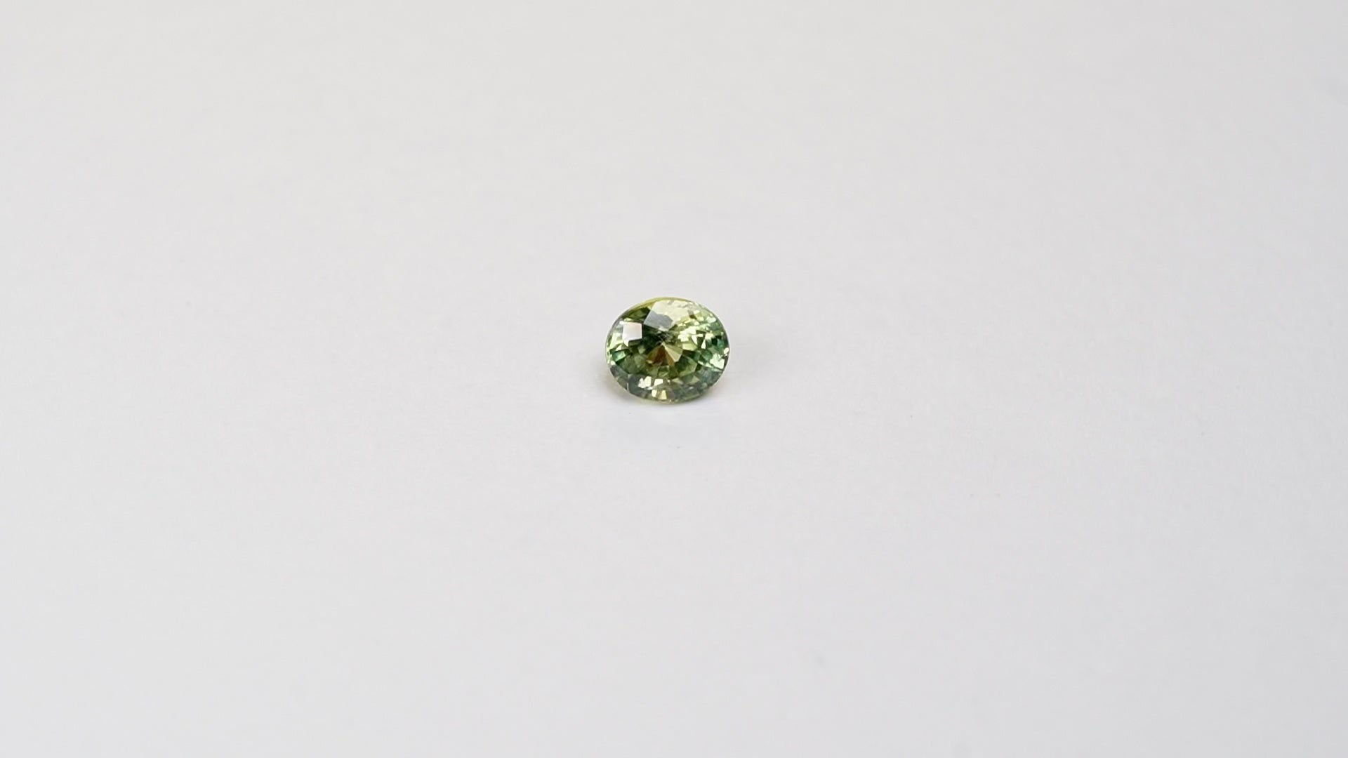 1 carat pear parti teal sapphire with mixed green and yellow color.