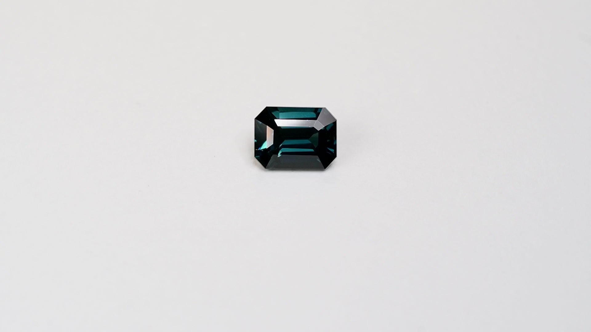 3.06 carat emerald cut teal parti sapphire with blue and green