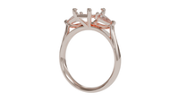 18 CARAT ROSE GOLD Sapphire trilogy engagement ring with pear cut diamonds.