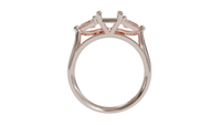 18 CARAT ROSE GOLD Sapphire trilogy engagement ring with pear cut diamonds.