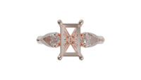 18 CARAT ROSE GOLD Sapphire trilogy engagement ring with pear cut diamonds.